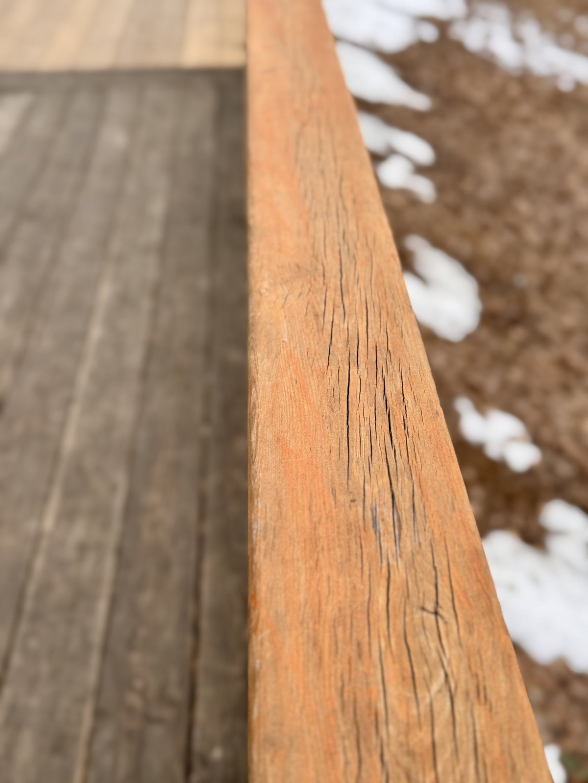 A beautifully maintained wooden deck featuring a sleek railing design that enhances outdoor enjoyment and atmosphere.